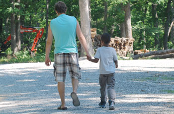 father and foster son hold hands | coyotehill.org
