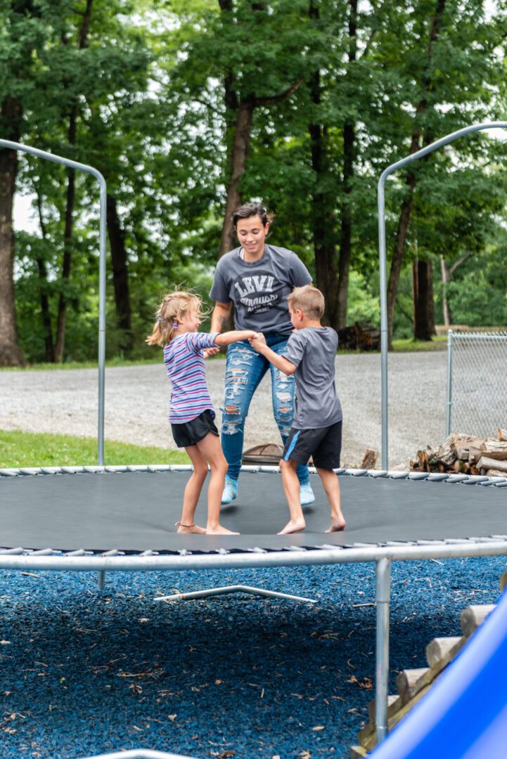 kids and adult on trampoline