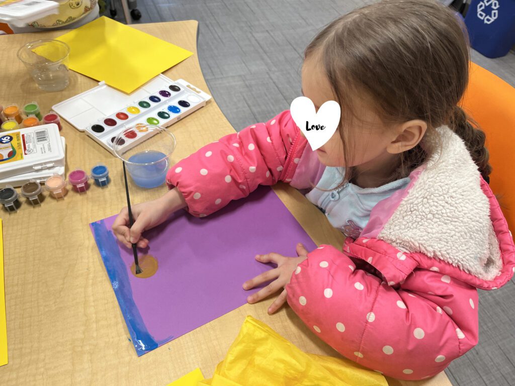 Child does a craft at a Coyote Hill Foster Care Ministries respite event.